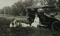 1912-Lydia Scheele on Fender of Snazzy Car - Roland Scheele on ground with unknown.JPG