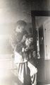 1952 - Ralph Baur in pajamas feeding baby Kathryn.jpg